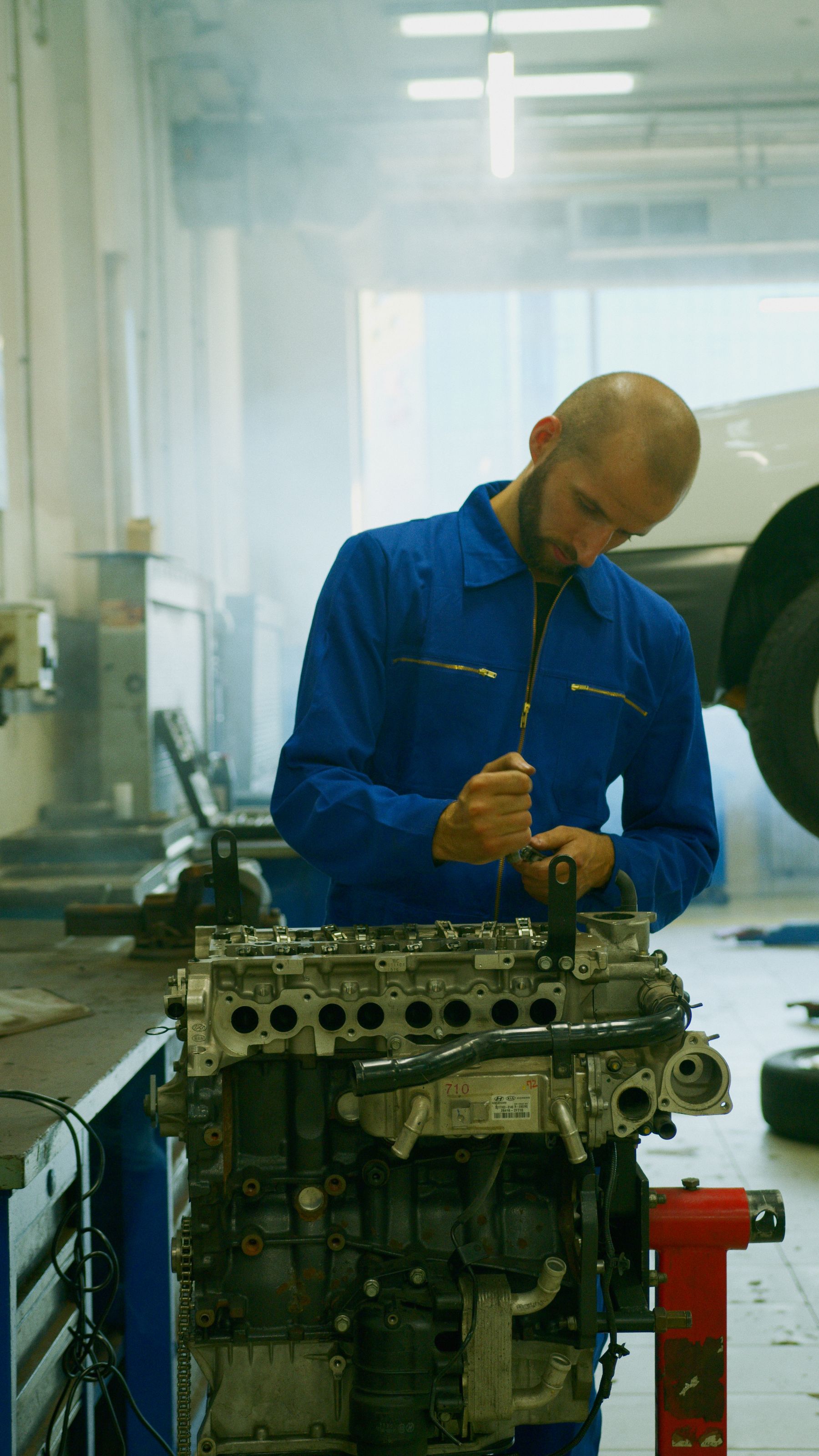 Mechanic working on an engine in a workshop